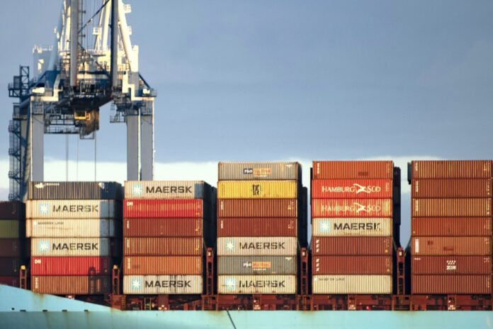 ZPMC container cranes at a port terminal at dusk — the port machinery maker named on the n0n 38-company ransom leak list